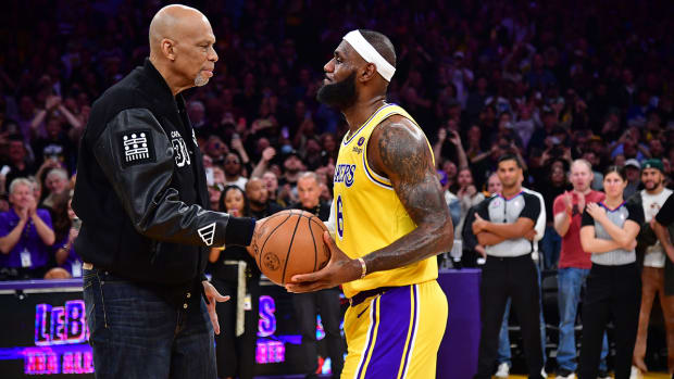 Los Angeles Lakers forward LeBron James (6) shakes hands with former player Kareem Abdul-Jabbar after breaking the NBA all time scoring record against the Oklahoma City Thunder during the second half at Crypto.com Arena.